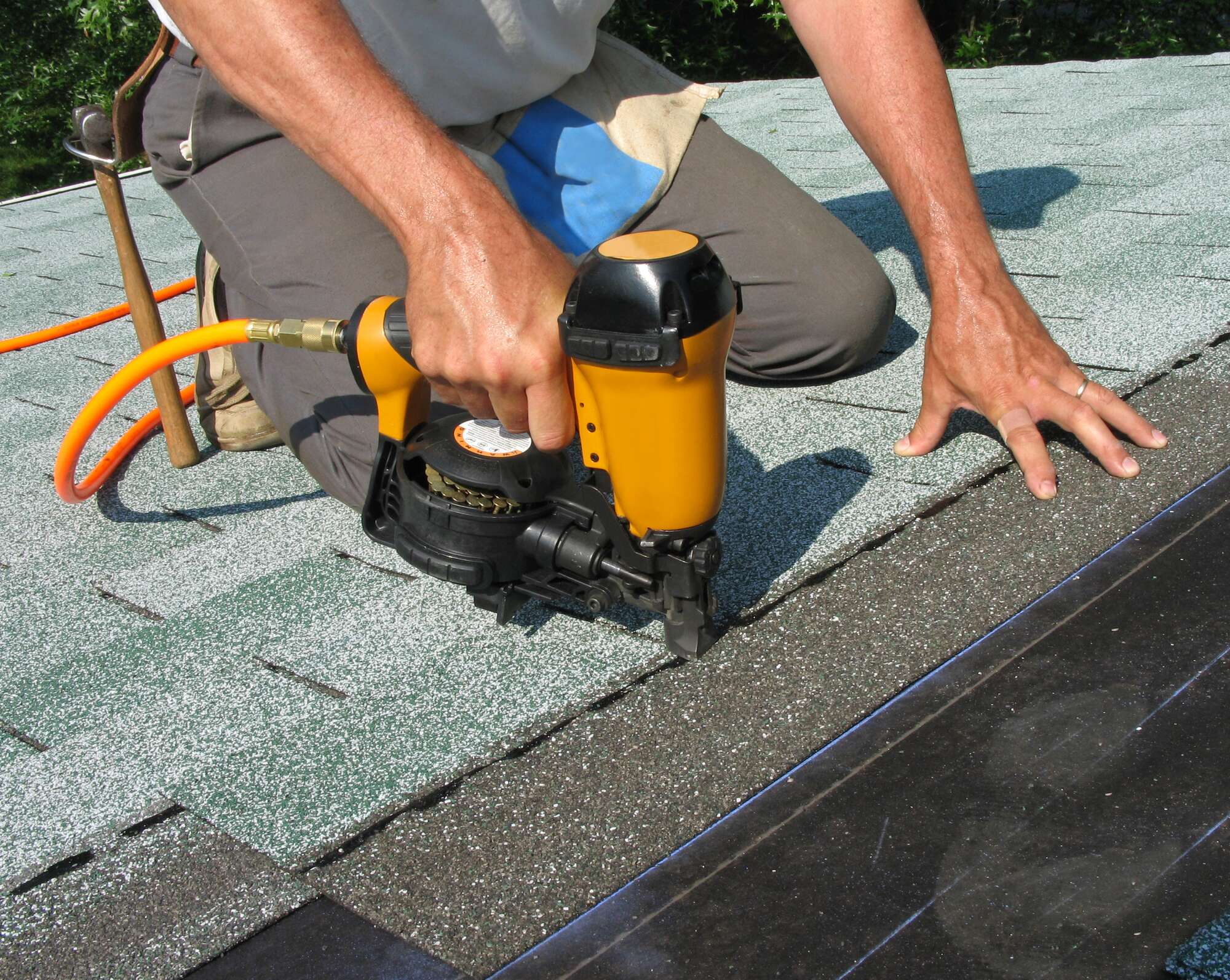 Man installing roof shingles
