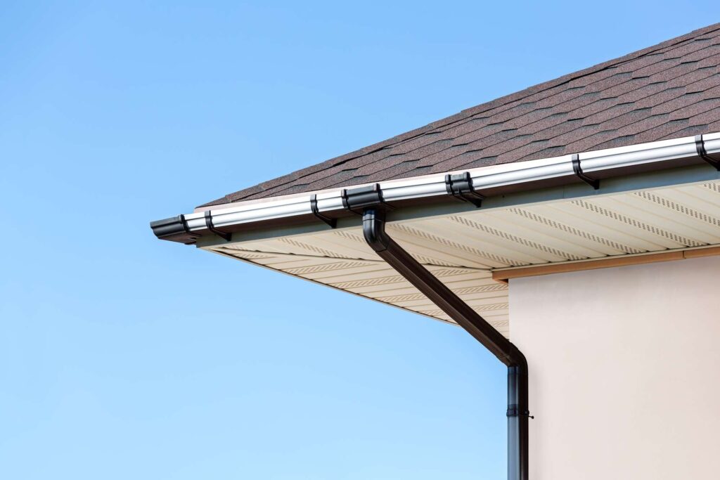 Close-up of a rain gutter with drainpipe on a Cleveland home