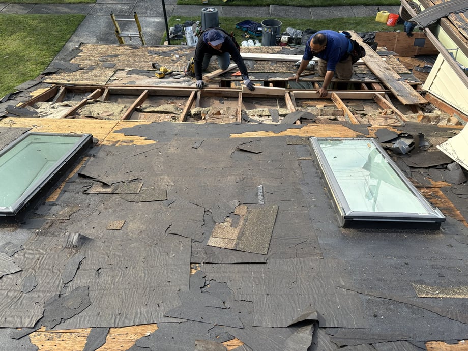 Workers tearing down the roof for repair