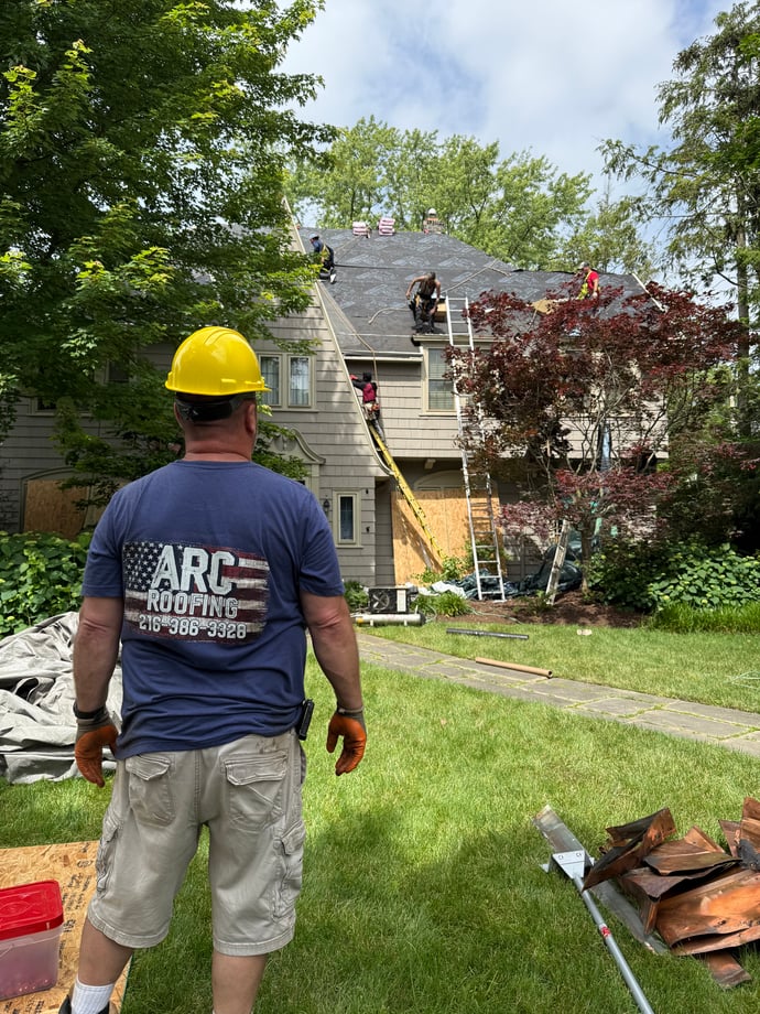 ARC Roofing & Home Improvement employees working on a residential roof