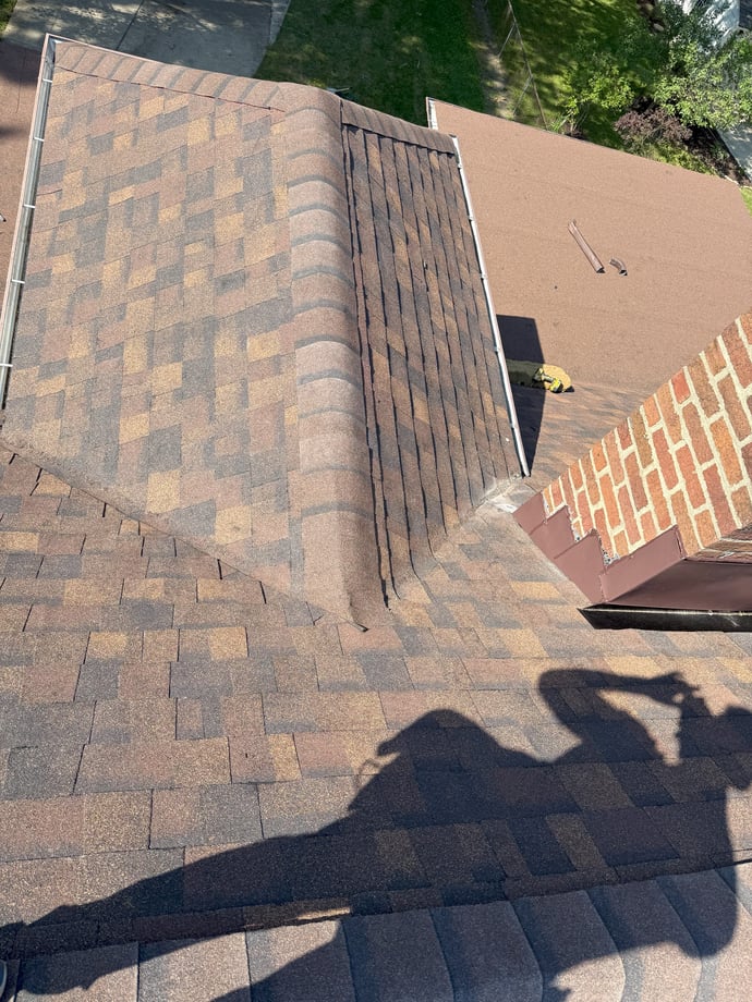 Shadow of a man working on the roof