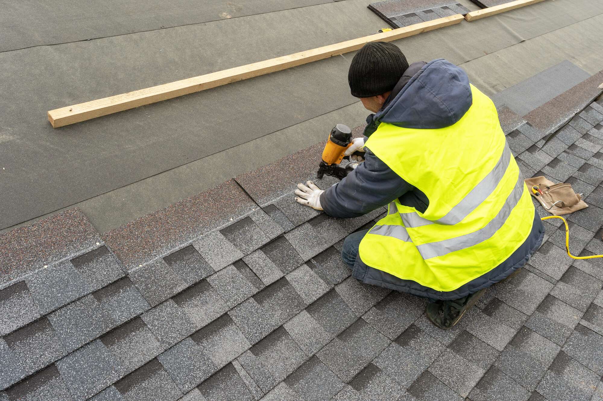 Man installing roof shingles
