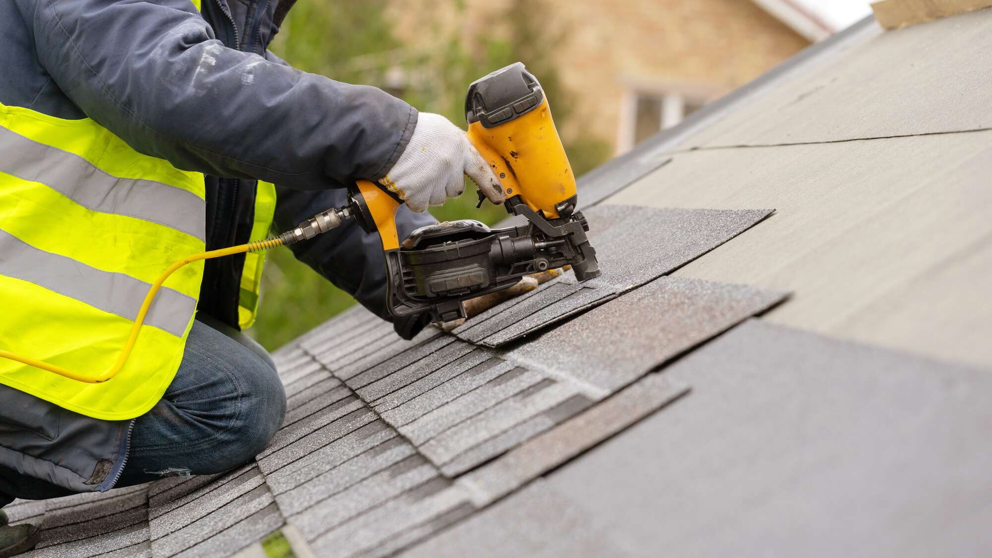 Man installing roof shingles
