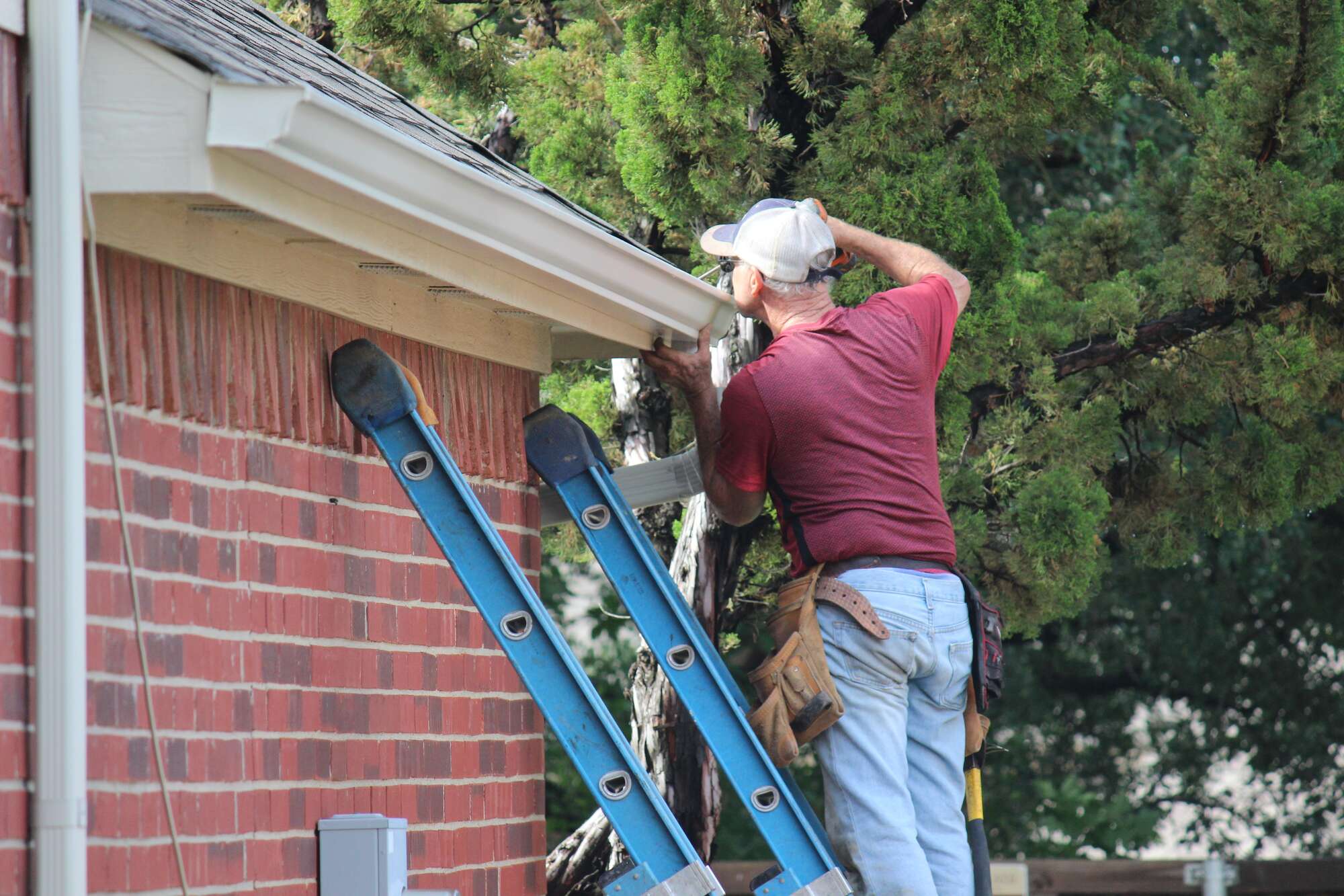Man fixing the roof gutter