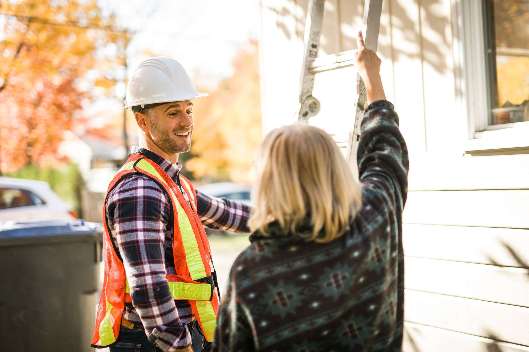 Female client talking with the roof worker