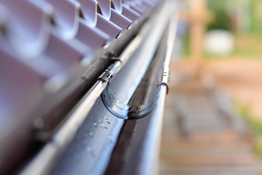Close-up of a seamless aluminum gutter on a Cleveland home, illustrating seamless vs sectional gutter systems